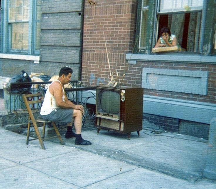 Man Watching TV on the Sidewalk