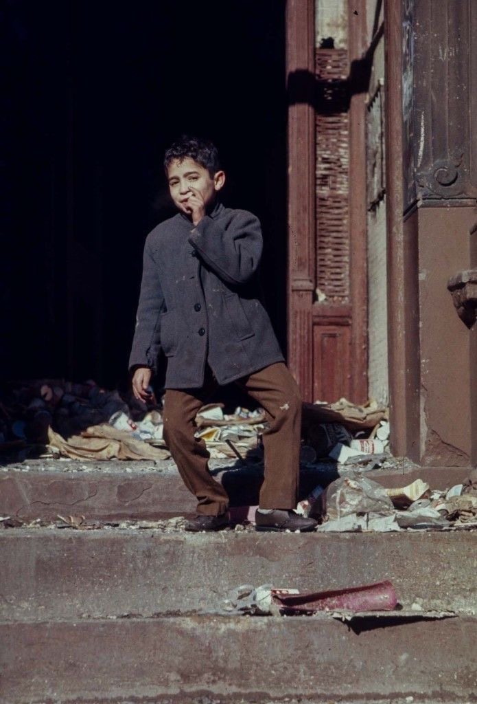 Boy Leaving Trash-Filled Building