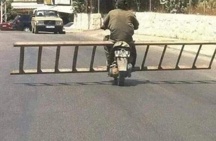 Motorcyclist Hauls Ladder Horizontally