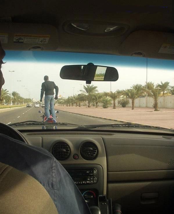 Standing on Motorcycle on Highway