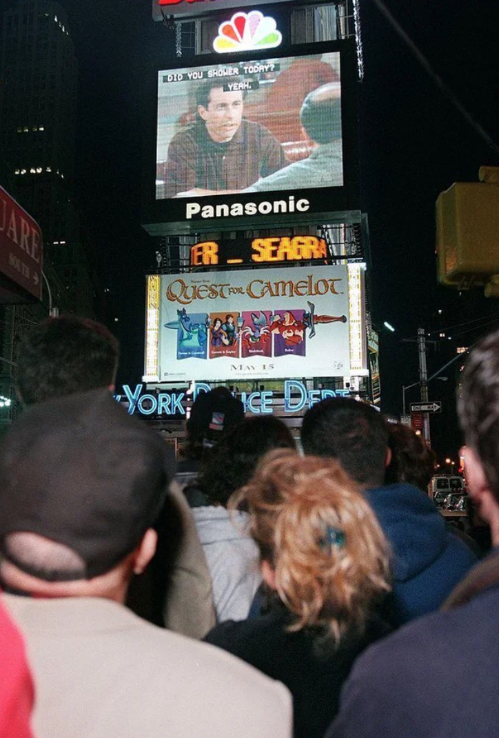 New Yorkers Watching Seinfeld on a Street Screen. 1990s