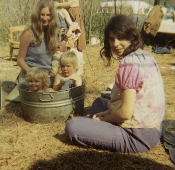 Women Bathing Babies Outside