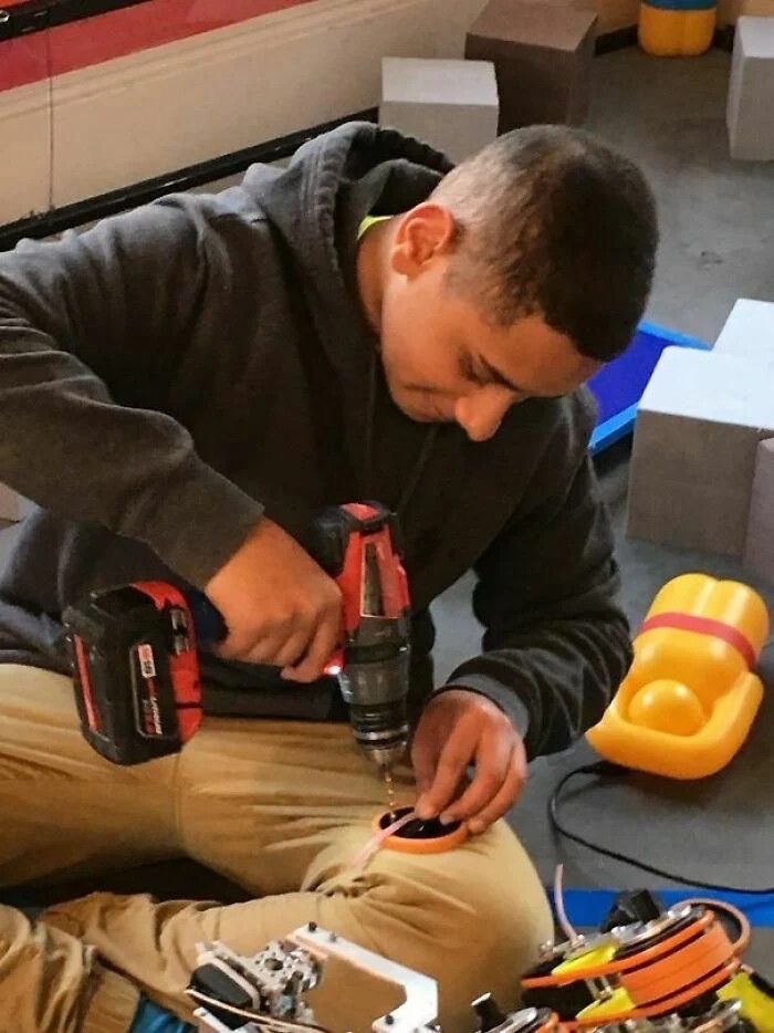 Boy Drilling Into a Thing on His Leg