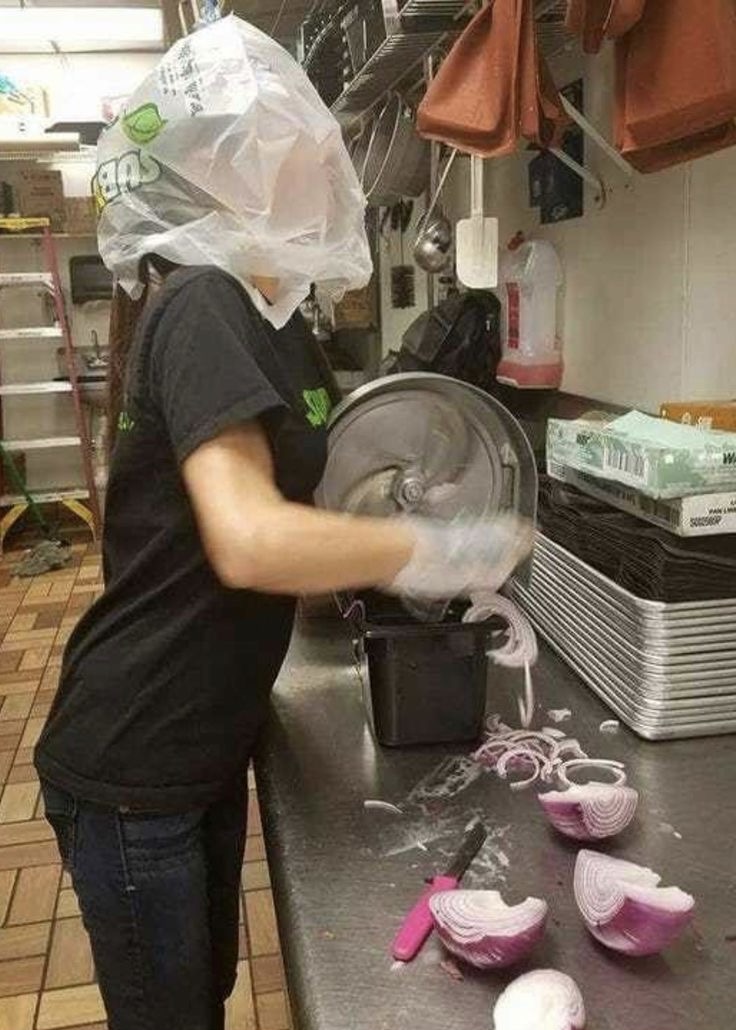 Girl Cutting Onions With a Plastic Bag on Her Head