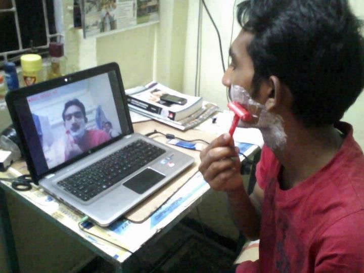 Guy Using a Computer Webcam as a Shaving Mirror