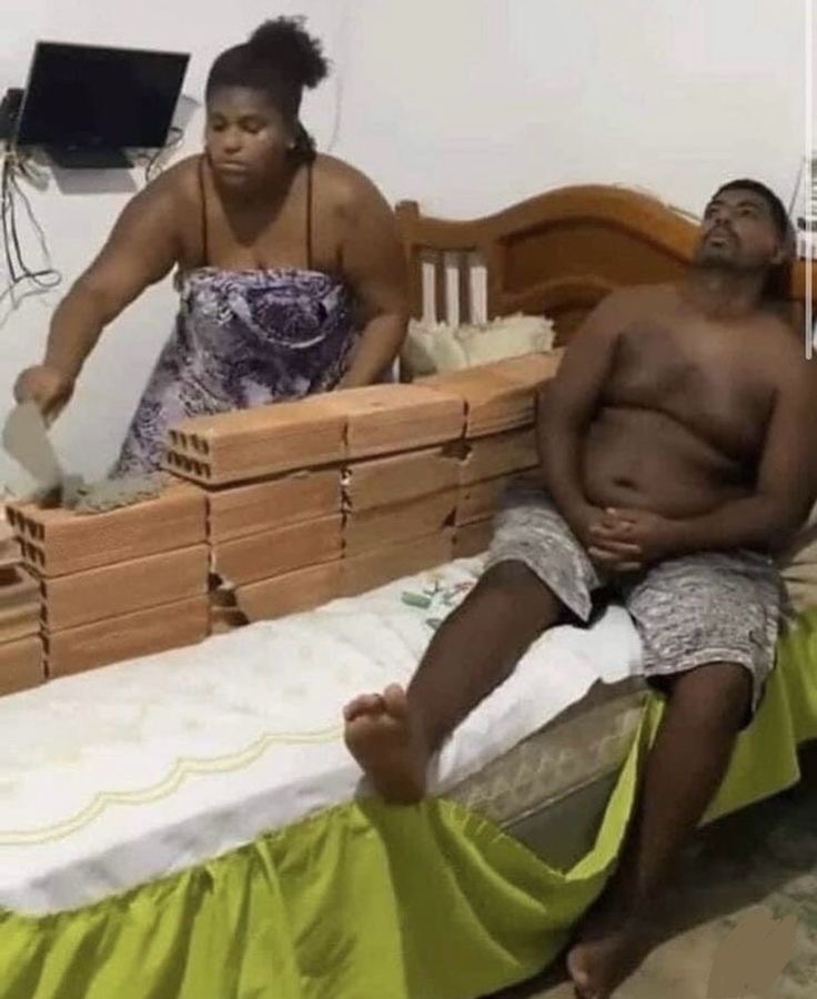 Woman Building a Brick Wall on Her Bed