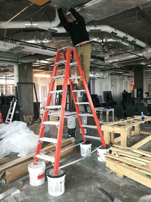 Ladder Sitting on Paint Cans 