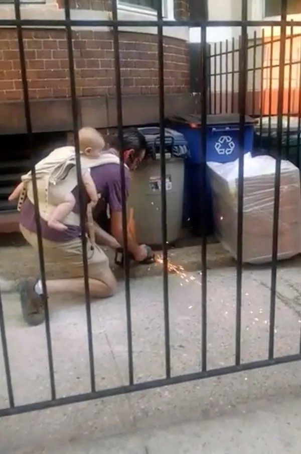 Dad Tackling Sparks With Baby in Back-Pack Mode