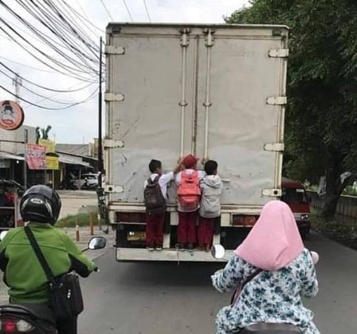 Kids Hanging Onto the Back of a Moving Truck