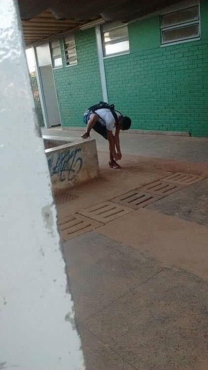 Boy Tying the Shoelace of the Foot That Isn’t Raised