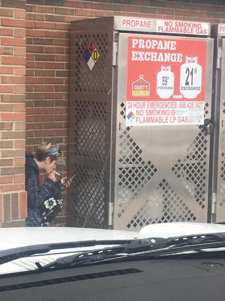 Boy Smoking Next to a No-Smoking Zone