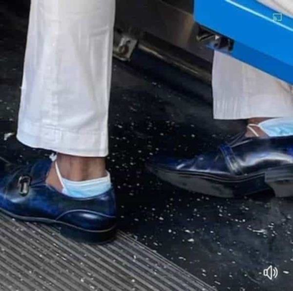 Man Wearing Face Masks on His Ankles 