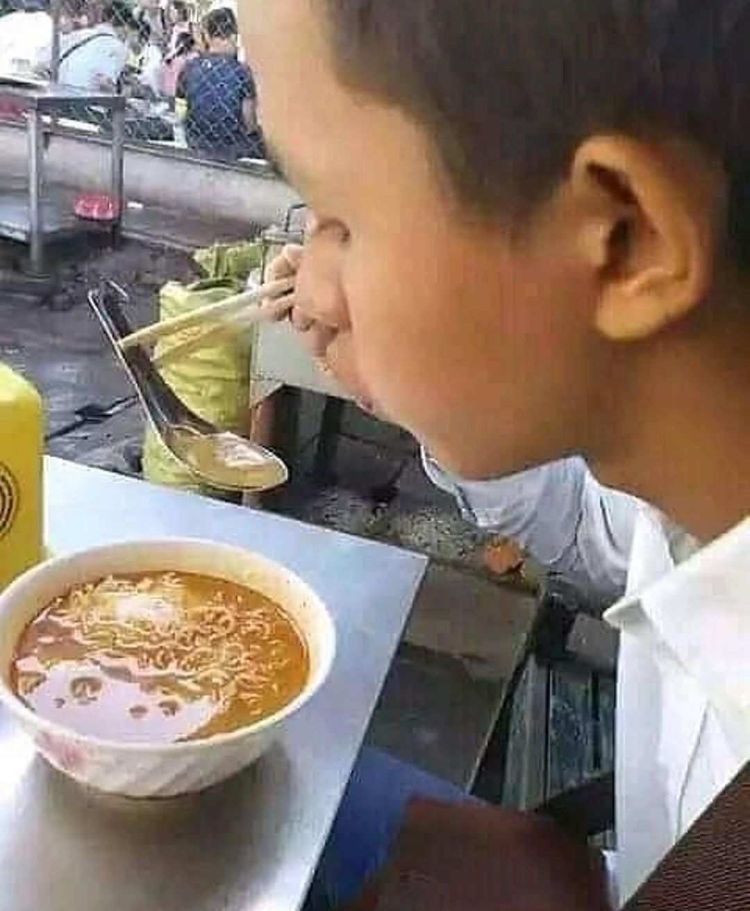Kid Holding a Spoon With Chopsticks 