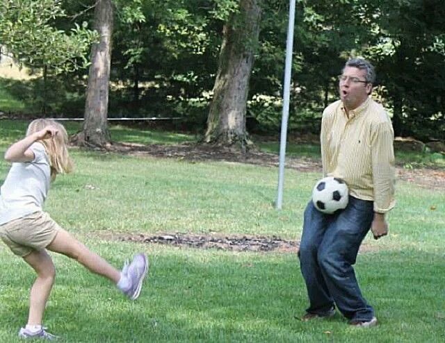 Girl Kicking a Ball Into Dad’s Private Parts