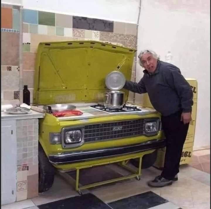 Man Cooking in a Car-Front Kitchen