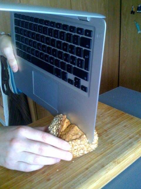 Person Cutting Bread with a Computer