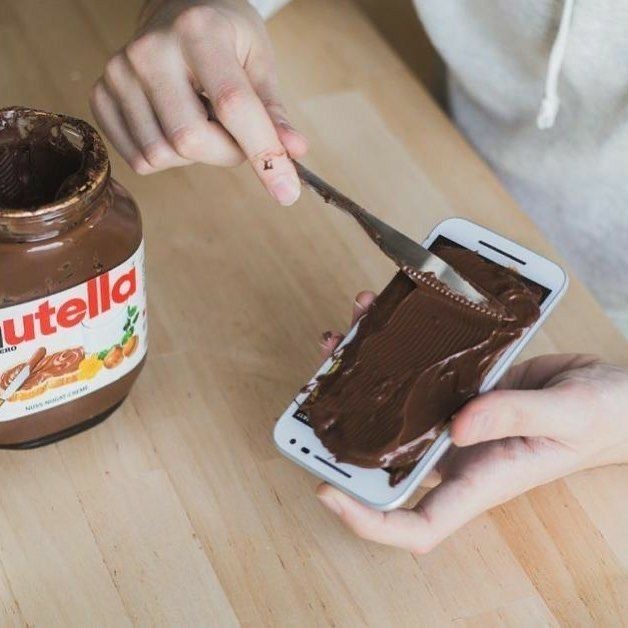 Girl Spreading Nutella on Her Phone