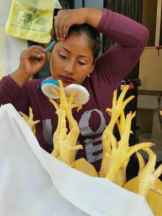 Girl Putting a Mirror into Chicken Feet