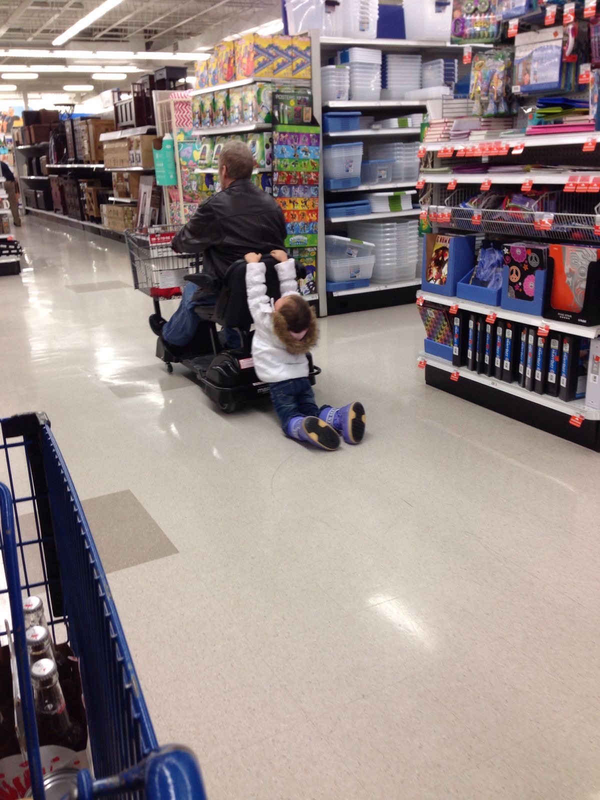 Man on Electric Scooter Dragging a Child