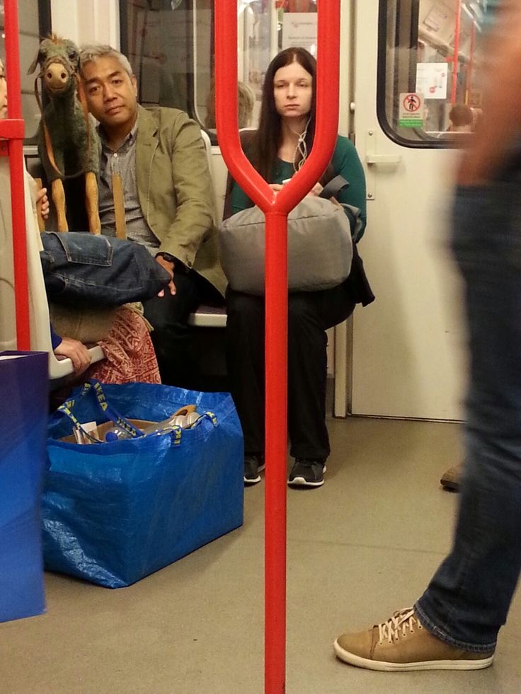 Guy Posing Next to a Toy Horse