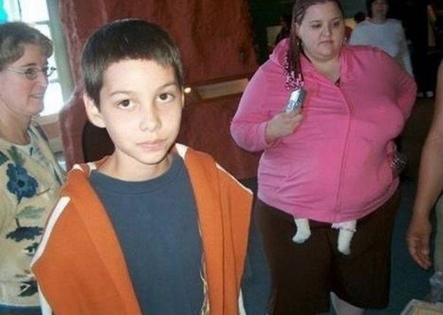 Kid Posing While a Woman Is In The Back…