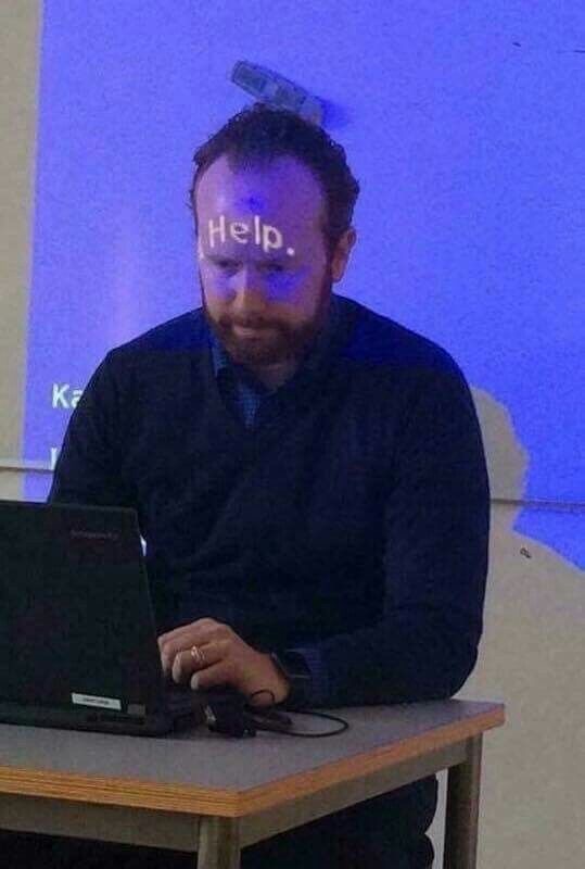 Teacher with ‘HELP’ Projected on His Forehead