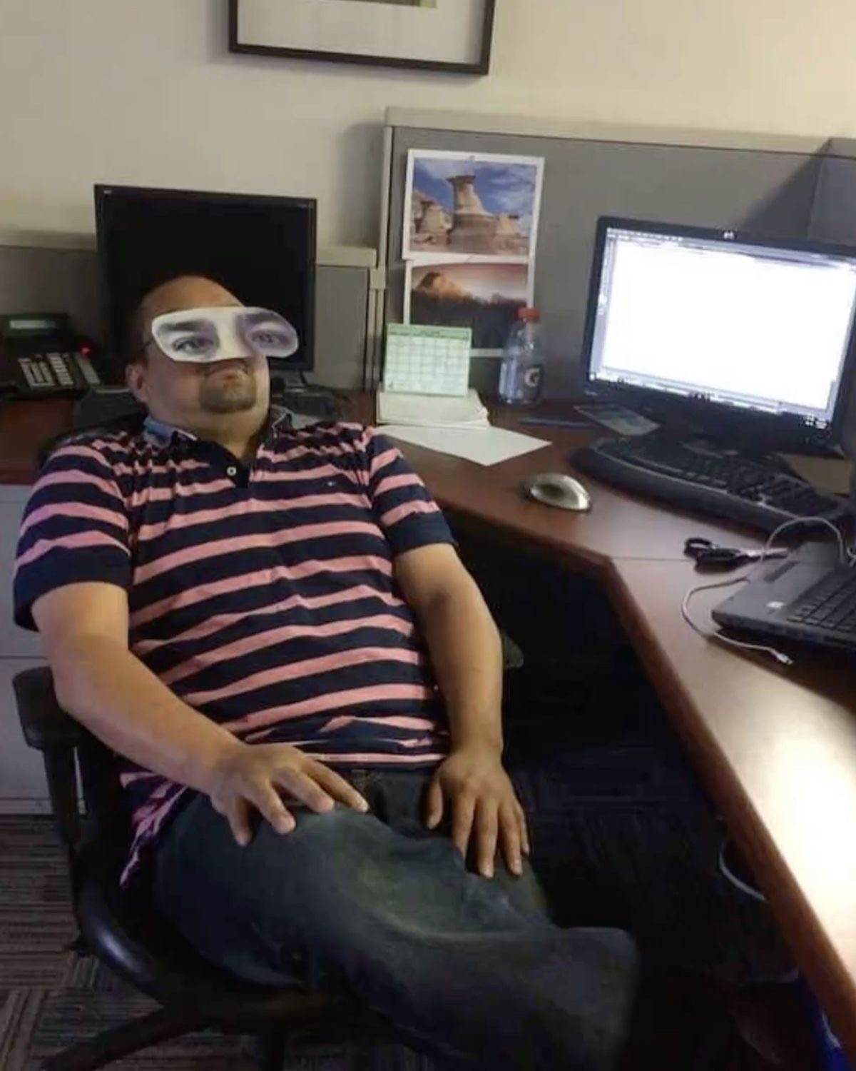 Man Asleep at Work Wearing Paper Eyes
