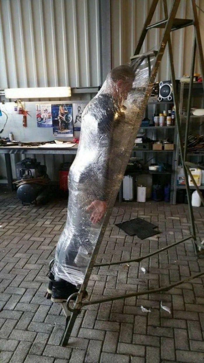 Man Wrapped to a Ladder With Plastic Wrap
