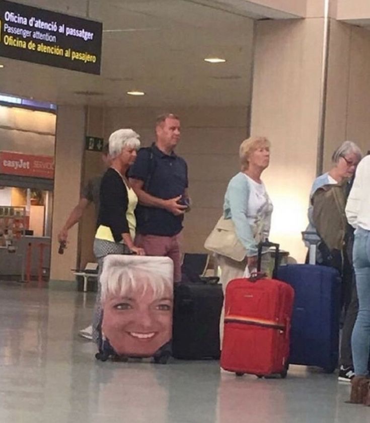 Woman with a Suitcase With a Giant Photo of Her Own Face