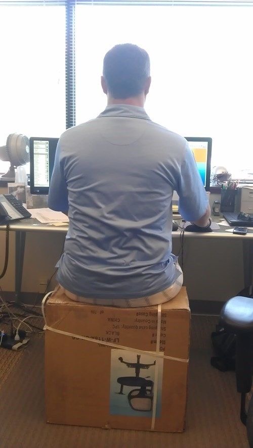 Man Sitting on the Box Containing the Chair