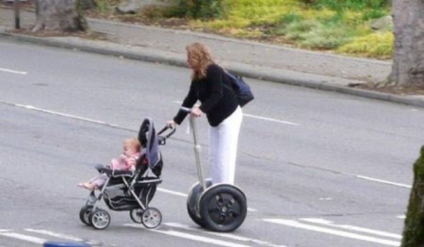Grandma on a Scooter Pulling a Baby in a Stroller