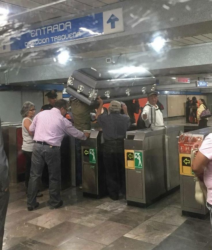 Carrying a Coffin Into the Subway