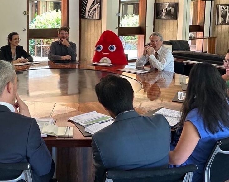 Company Meeting Featuring One Person in a Giant Red Costume