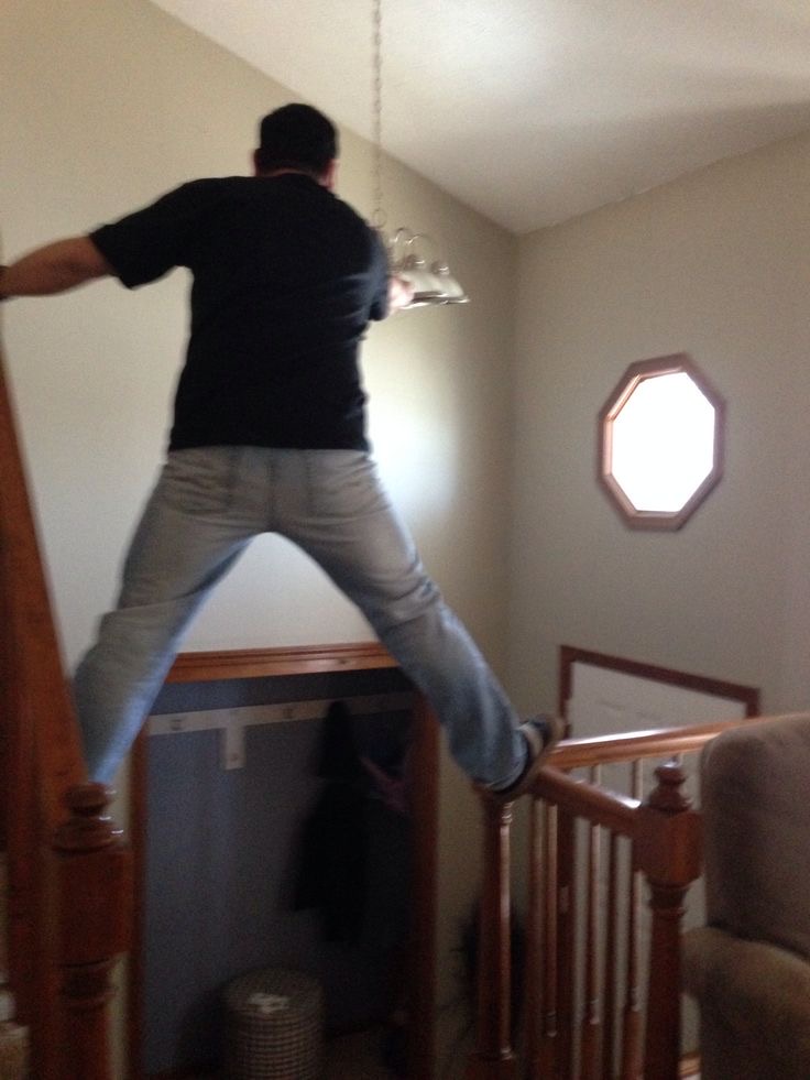 Man Standing on Stair Rails