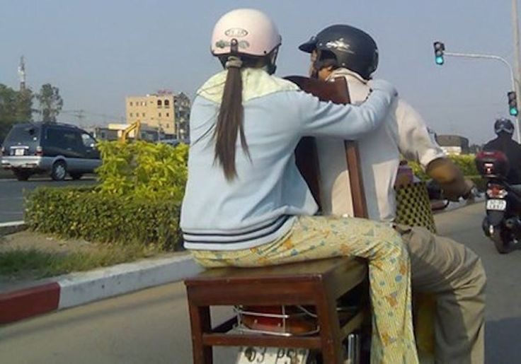 Girl Sitting on a Chair on the Back of a Motorcycle