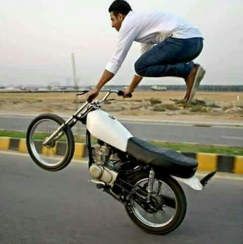 Guy Jumping in Mid-Air While Riding a Motorcycle