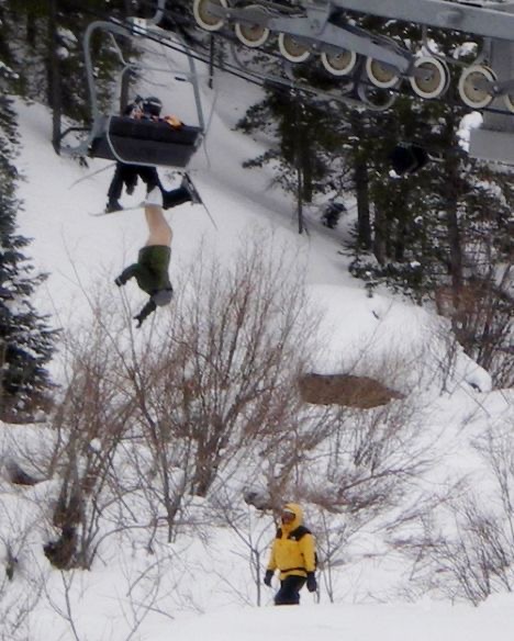 Person Hanging From a Snow Chairlift
