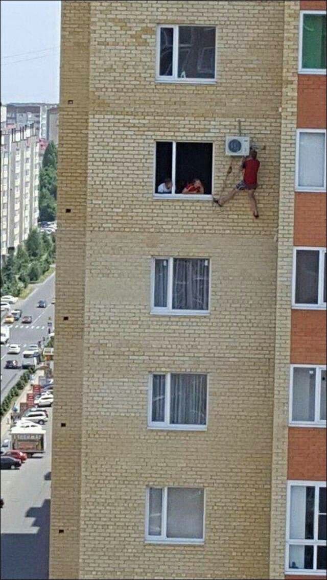 Man Dangerously Fixing an AC Unit