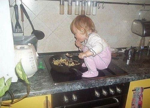 Baby Sits on the Stove Eating Food