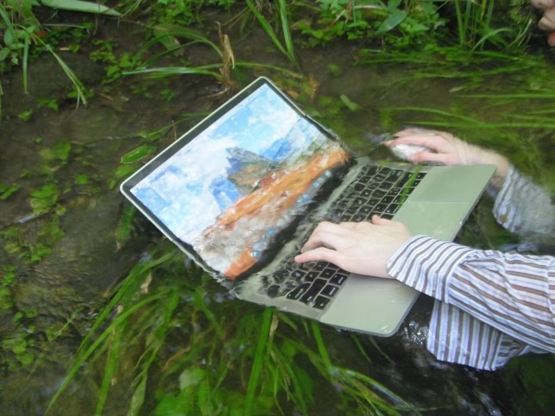 Person Uses a Laptop Underwater in a Lake