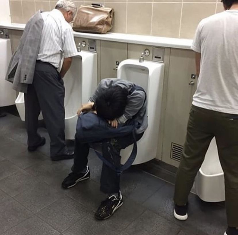 Guy Sleeping Inside a Urinal