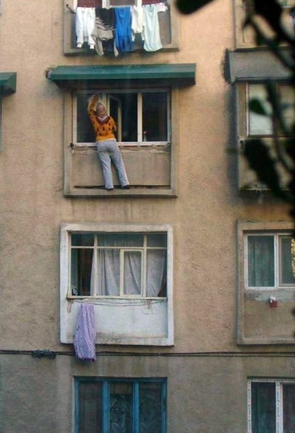 Lady on Ledge Cleaning Window (Again!)