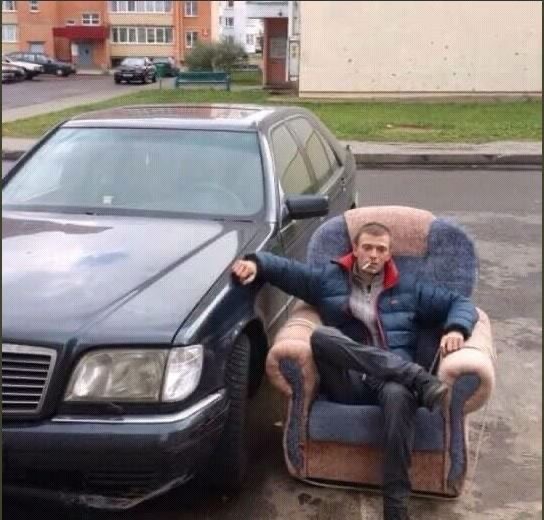 Guy Smoking on His Couch Beside His Car