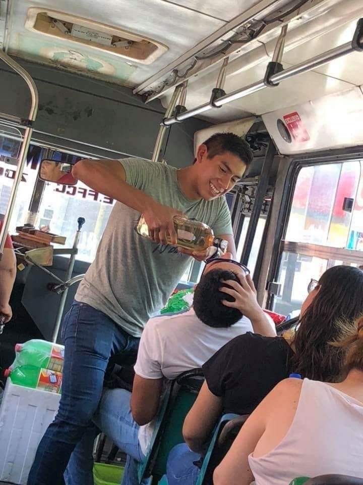 Guy Giving Another Guy Shots on a Bus