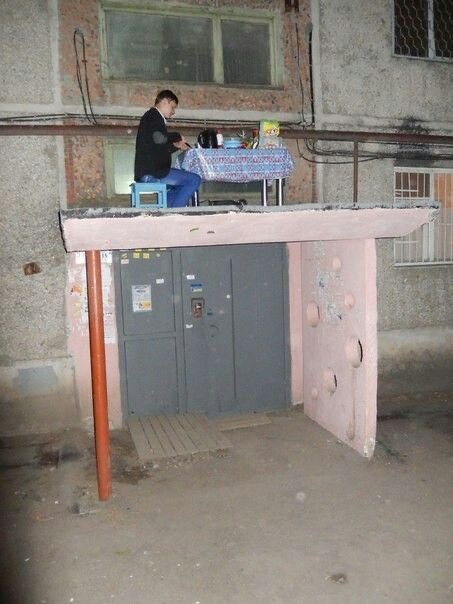 Guy Eating Dinner in a Strange Abandoned Structure
