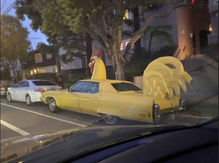Car Decorated With a Rooster Head and Tail