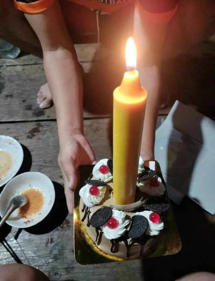 Tiny Cake With a Candle the Size of a Lamppost