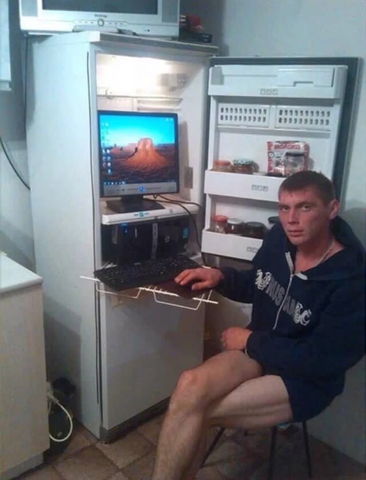 Guy Using His Computer Inside the Fridge