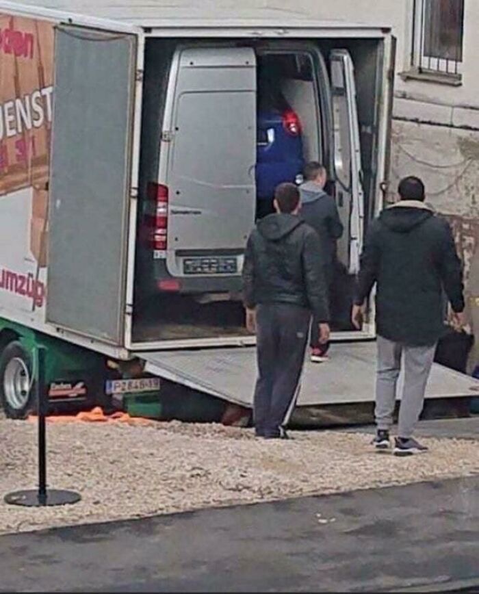 A Truck Carrying a Smaller Truck Carrying a Car