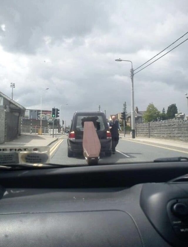 Coffin Falls Out of Car Window 